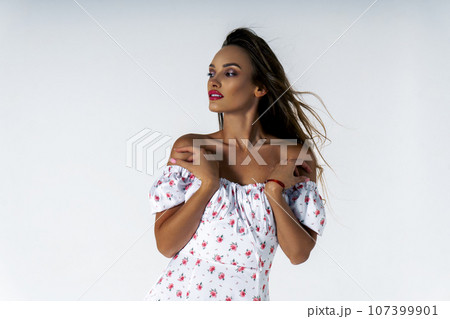 Gorgeous young adult woman posing in studio on white background 107399901