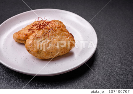 Delicious fried cutlets or meatballs with salt, spices and herbs 107400707