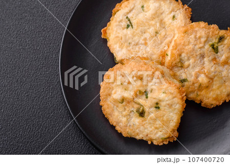 Delicious fried minced fish cutlets or meatballs with salt, spices and herbs 107400720