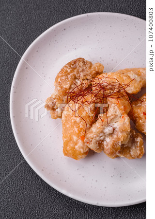 Delicious juicy grilled chicken pieces in sweet and sour sauce with salt and spices 107400803