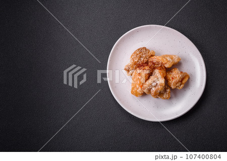 Delicious juicy grilled chicken pieces in sweet and sour sauce with salt and spices 107400804