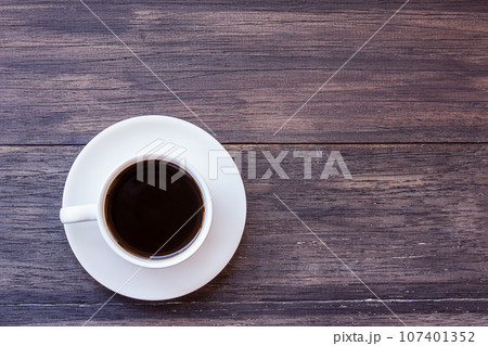 Cup of coffee on wooden table Cup of coffee on wooden table 107401352