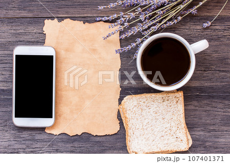 Old paper on dark wooden table background. 107401371