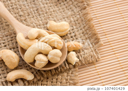 Close up cashews in wooden spoon 107401429