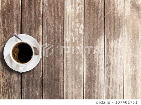 Cup of coffee on wooden table background Cup of coffee on wooden table background 107401751