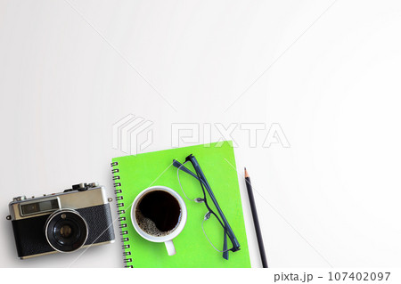 Cup of coffee and vintage camera on white background Cup of coffee and vintage camera on white background 107402097