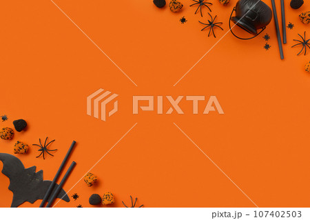 Halloween decor on an orange black background. Flat lay top view 107402503