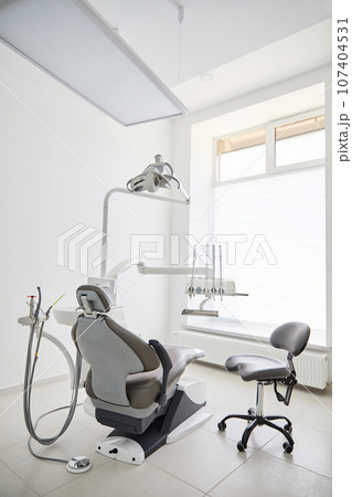 Dentist's office interior with modern chair and special dentisd equipment. Dentist office. Dentist chair in high class dental clinic. Dentist office. Medical concept. Dentist's office interior with modern chair and special dentisd equipment. Dentist office. Dentist chair in high class dental clinic. Dentist office. Medical concept. 107404531