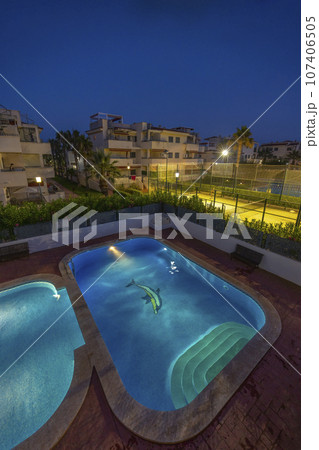 illuminated swimming pool at night 107406505
