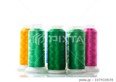 set of different color sewing threads,on white background. set of different color sewing threads,on white background. 107410639