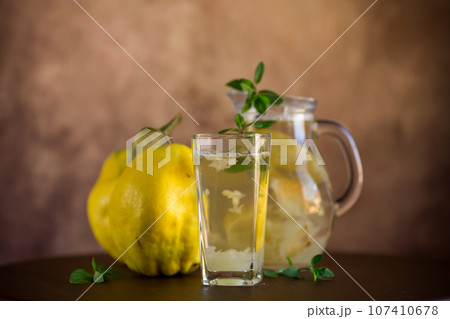 Prepared compote from ripe natural autumn quince, in a glass glass and decanter . 107410678