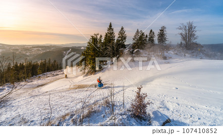 Snowmaking in the mountains in early winter. Tanvaldsky Spicak ski resort in Jizera Mountains, Czech Republic Snowmaking in the mountains in early winter. Tanvaldsky Spicak ski resort in Jizera Mountains, Czech Republic 107410852