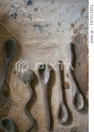 Close up clay spoon on rustic background Close up clay spoon on rustic background 107411902