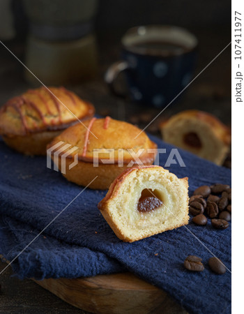 Pasticciotto leccese pastry filled with egg custard cream and sour cherry jam close up Pasticciotto leccese pastry filled with egg custard cream and sour cherry jam close up 107411977