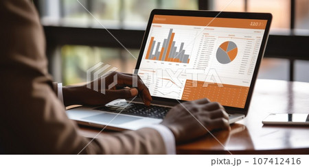 Close-up photo of a hands of an African American man with laptop. Trading cryptocurrency and securities. 107412416