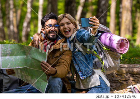 Happy travelers making selfie and looking enjoyed 107412846