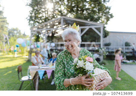 Beautiful senior birthday woman with paper crown on head. Beautiful senior birthday woman with paper crown on head. 107413699