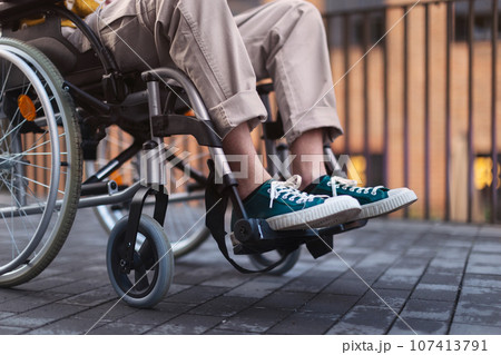 Close up of young gen Z boy in a wheelchair in the city. 107413791