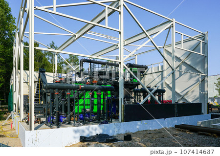 Steel framework of new wood chip biofuel heat power station before installing wall sandwich panels 107414687