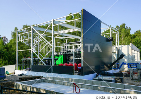 Steel framework of new wood chip biofuel heat power station before installing wall sandwich panels 107414688