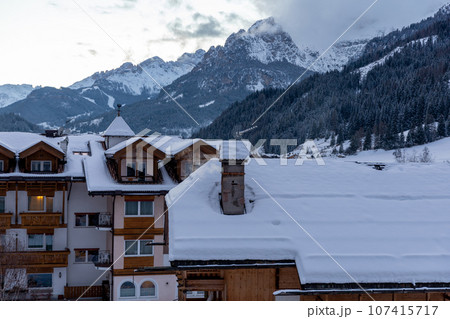 Winter Italy Dolomite village in mountains covered with snow Winter Italy Dolomite village in mountains covered with snow 107415717