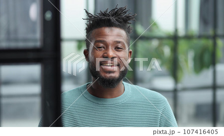 African American man in green sweater looking at camera African American man in green sweater looking at camera 107416405