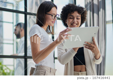 business woman with her staff in background at office 107416441
