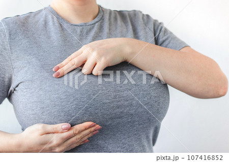 Young woman doing breast self-diagnosis. Breast Cancer Awareness Month. Women's health care Young woman doing breast self-diagnosis. Breast Cancer Awareness Month. Women's health care 107416852