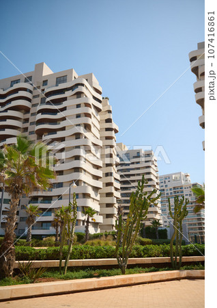 Contemporary high rise buildings with glass mirrored and geometric walls of modern Casablanca city under blue sky 107416861