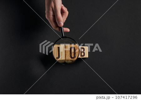 Magnifying glass on word work on black background Magnifying glass on word work on black background 107417296