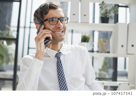 Man accountant or business lawyer talking on smartphone Man accountant or business lawyer talking on smartphone 107417341