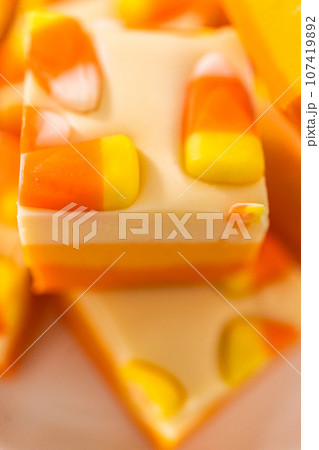 Homemade candy corn fudge square pieces on a white plate. Homemade candy corn fudge square pieces on a white plate. 107419892