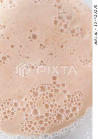 Activating an instant yeast in a glass mixing bowl. 107420200