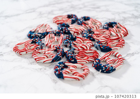 American flag. Red, white, and blue chocolate-covered pretzel twists. 107420313