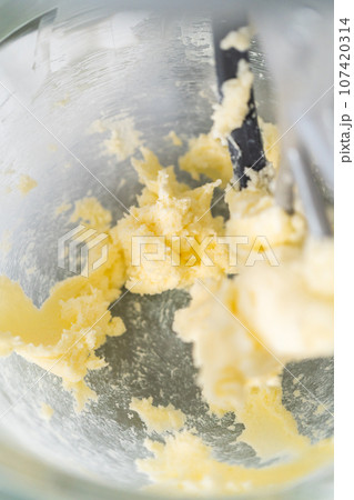 Lemon wedge cookies with lemon glaze. Mixing ingredients in kitchen mixer to bake lemon wedge cookies with lemon glaze. 107420314