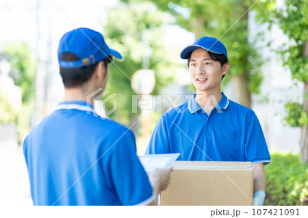 荷物を届ける宅急便の男性ドライバー 107421091