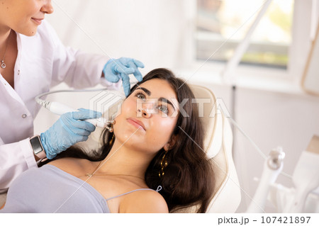 Facial Beauty massage to brunette girl Facial Beauty massage to brunette girl 107421897