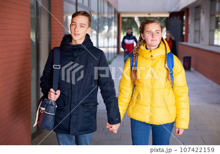 Young pretty couple of student boy and girl together outside happy smiling Young pretty couple of student boy and girl together outside happy smiling 107422159