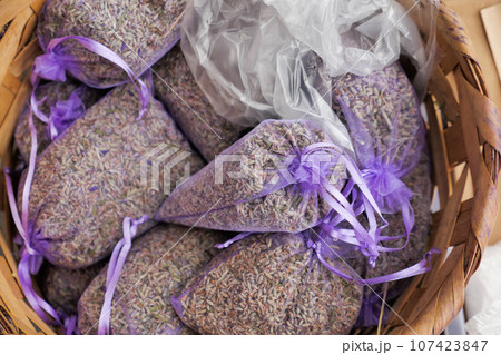 Pouch with lavender in a wooden basket.  107423847