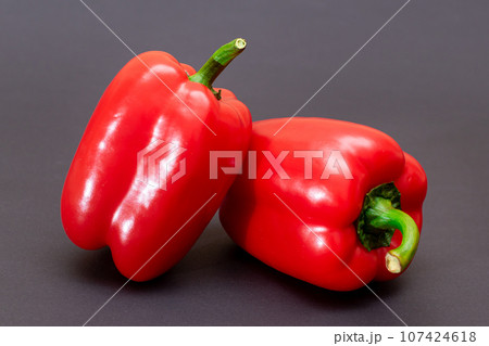 Red Bell Peppers on Black Background 107424618