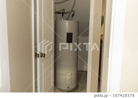 Automatic Storage Water Heater 75 Gal In Storeroom. Modern Electric Boiler, Water Tank in Storehouse In House. Horizontal Plane Automatic Storage Water Heater 75 Gal In Storeroom. Modern Electric Boiler, Water Tank in Storehouse In House. Horizontal Plane 107428378