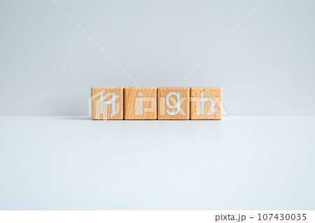 Wooden blocks form the text "High" against a white background. Wooden blocks form the text "High" against a white background. 107430035