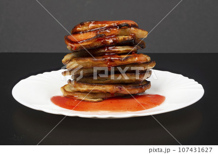 A stack of fresh, delicious pancakes with red berry syrup. Breakfast, dessert A stack of fresh, delicious pancakes with red berry syrup. Breakfast, dessert 107431627