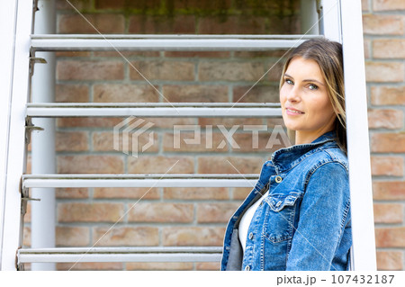 Stylish Blonde Millennial Woman on Metal Stairs Stylish Blonde Millennial Woman on Metal Stairs 107432187