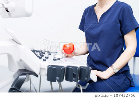 Female doctor sitting in office in a hospital with ultrasound diagnostic equipment 107432756