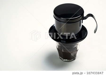 Cup of coffee with a Vietnam drip coffee maker 107433847