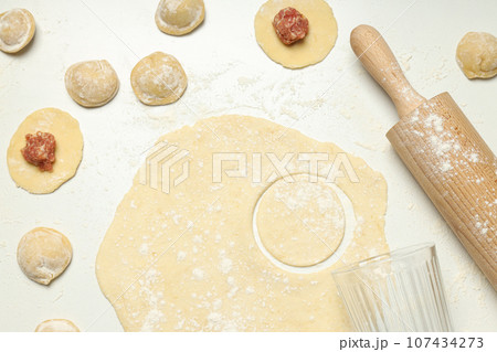 Cooking home food concept with raw dumplings Cooking home food concept with raw dumplings 107434273