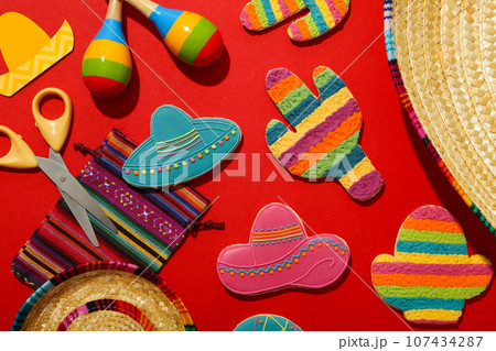 Mexican maracas, cactus and sombrero on color background Mexican maracas, cactus and sombrero on color background 107434287