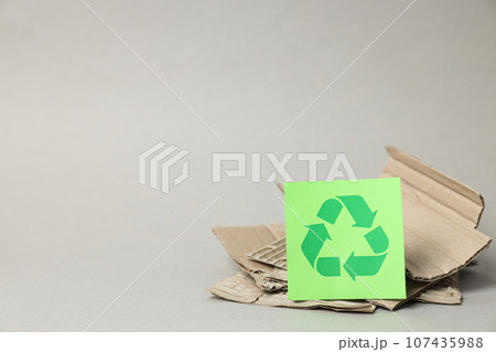 Sign of recycling of kraft cardboard, environmental protection. Smart use of resources. Sign of recycling of kraft cardboard, environmental protection. Smart use of resources. 107435988