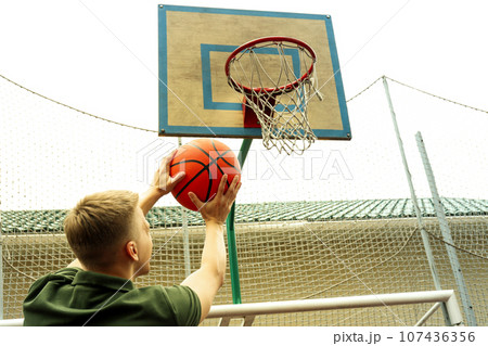 Man throw the ball in basketball hoop Man throw the ball in basketball hoop 107436356